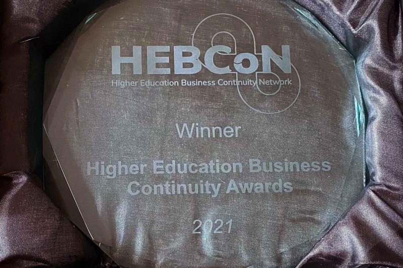 Round glass trophy in black satin presentation box, engraving on trophy reads: HEBCoN, Winner, Higher Education Business Continuity Network Awards, 2021