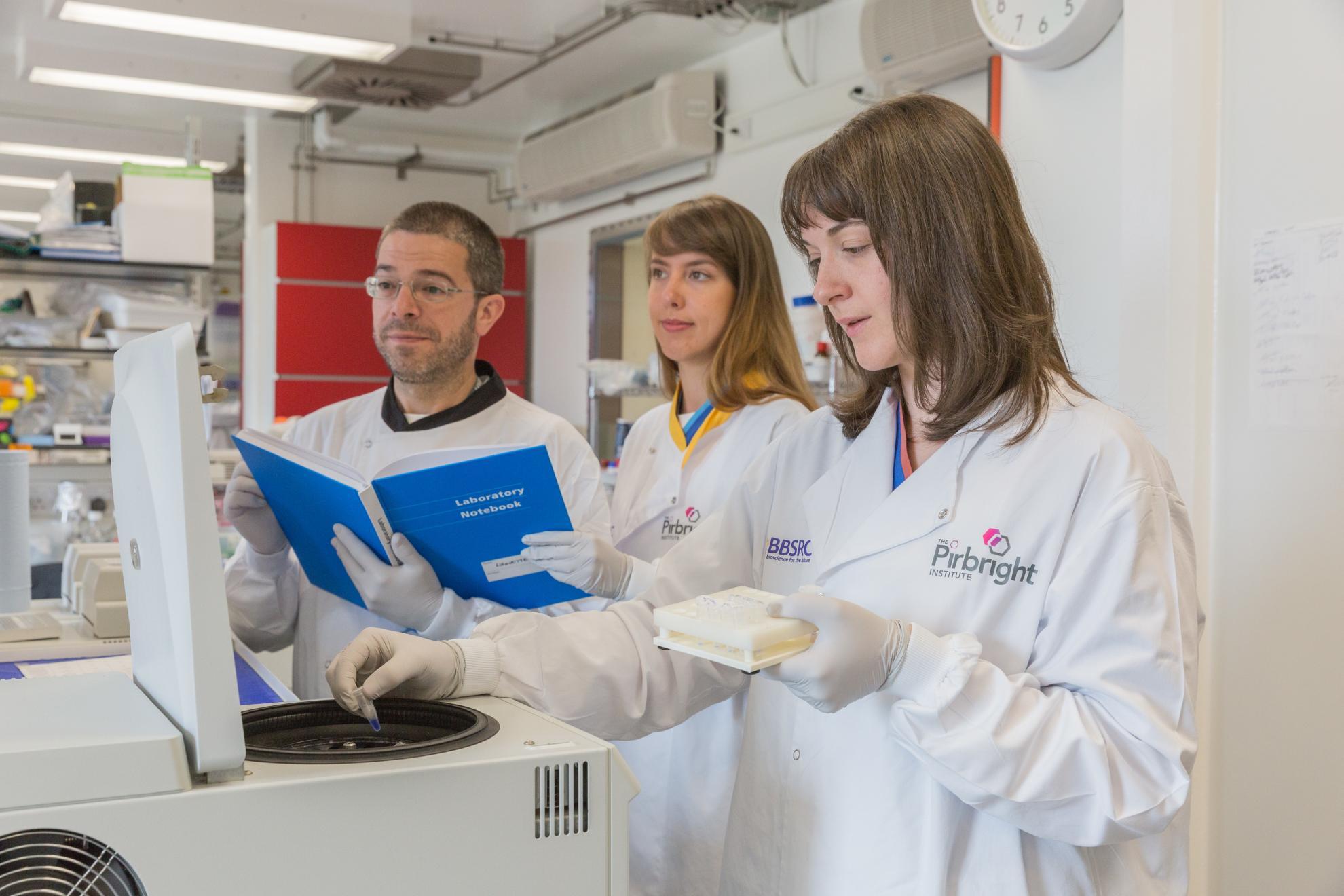 Male and female scientists at centrifuge