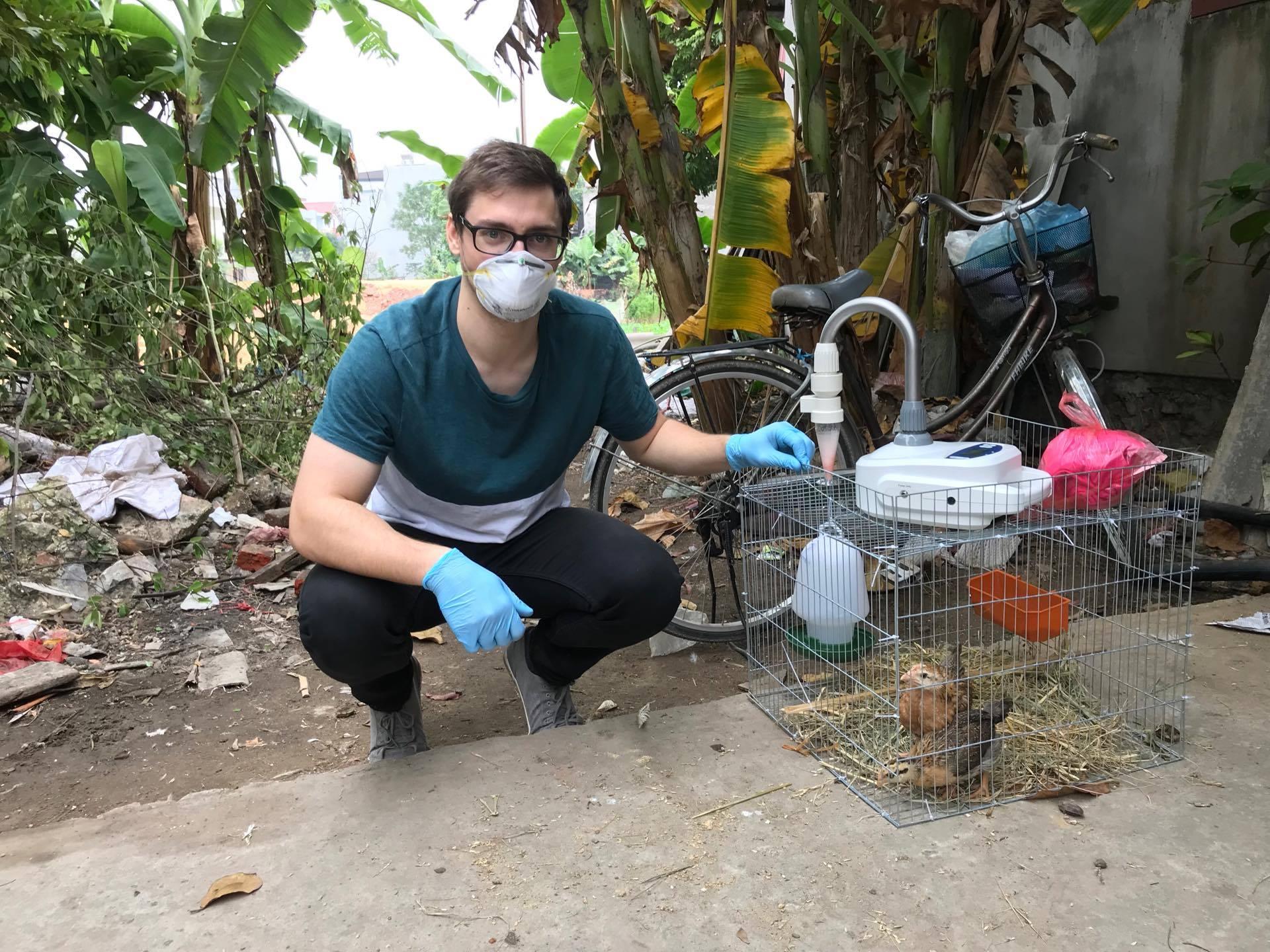 Joshua Sealy air sampling for avian flu in Vietnam Joshua Sealy air sampling chickens for avian flu in Vietnam