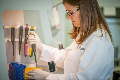 Female scientist in lab Female scientist pipetting